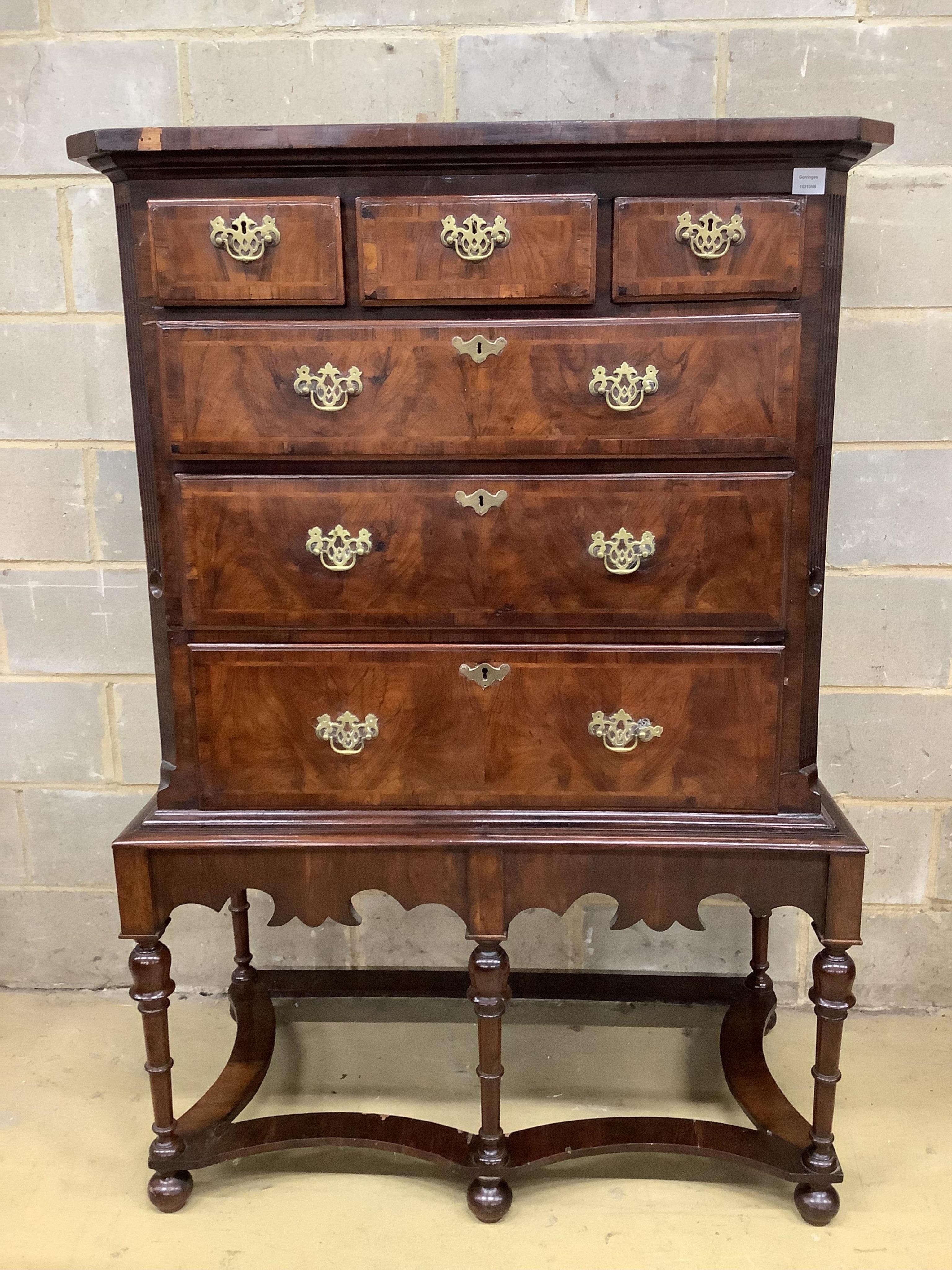 An 18th century walnut chest on later stand, width 106cm, depth 56cm, height 159cm. Condition - fair to good